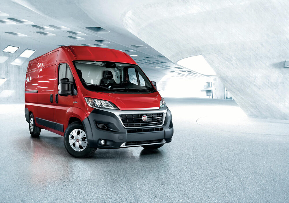 red fiat ducato parked in white car park