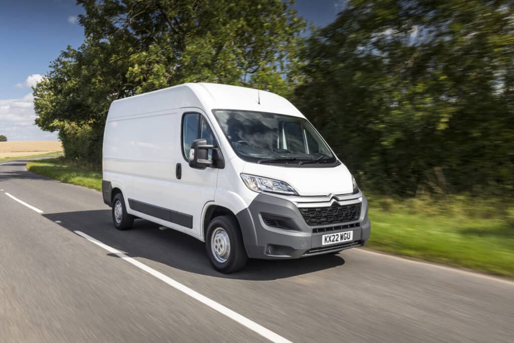 white citroen relay van driving on a sunny road