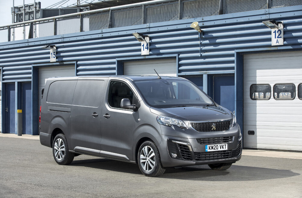 Grey Peugeot Expert Van beside garage doors