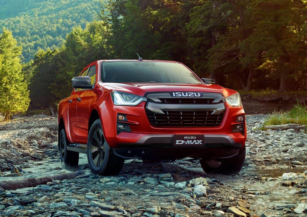 red isuzu dmax dl20 pick up truck on a field