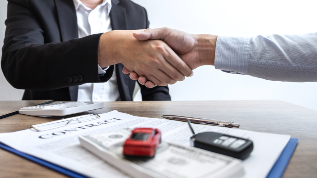 Shaking hands with a car finance lease employee